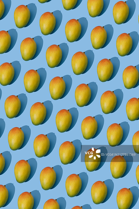 蓝色背景上的重复芒果图案图片素材