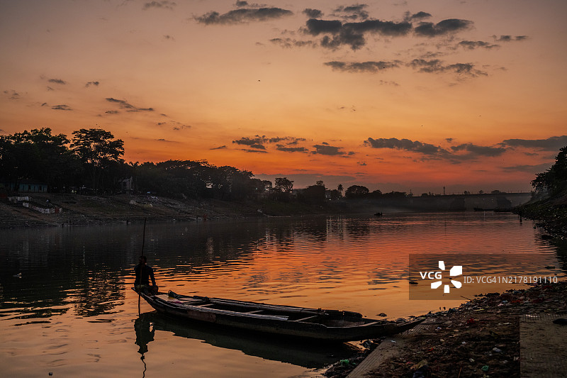 孟加拉国西尔赫特苏尔马河上的孤独船夫在日落时分图片素材