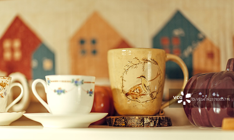 秋季主题装饰架子上的复古杯子和马克杯图片素材
