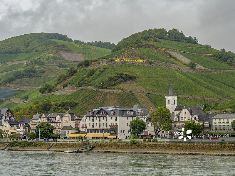 德国宾根莱茵河畔的田园村庄，教堂周围环绕着绿色葡萄园和丘陵图片素材