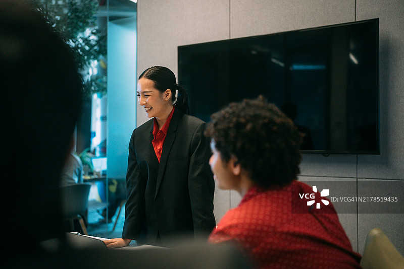 一位专注的导师在公司会议室里向学员们解释项目的重要性。图片素材