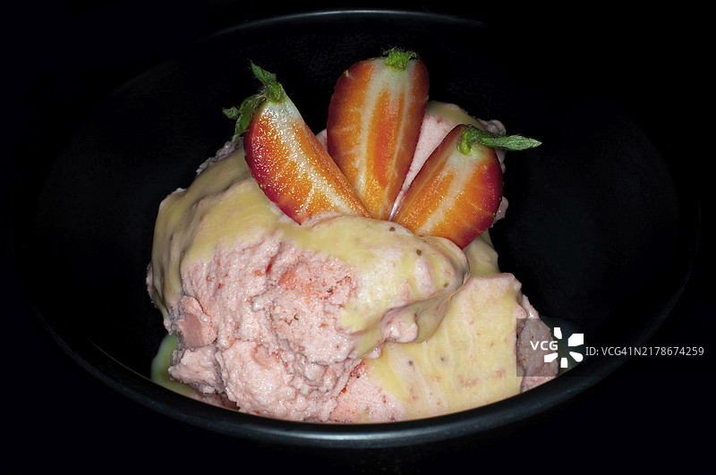 自制草莓冰淇淋，搭配新鲜水果和蛋酒，黑色背景影棚摄影图片素材