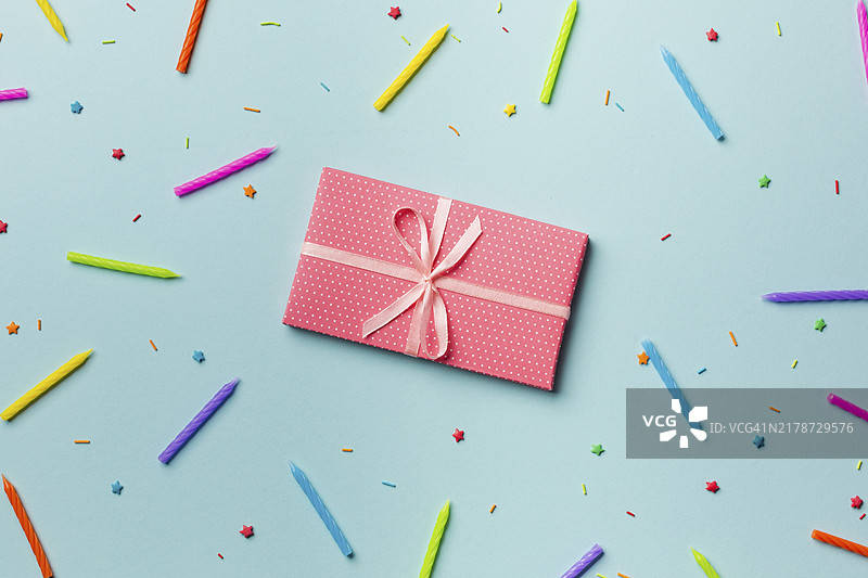 彩色蜡烛背景下的礼品盒图片素材