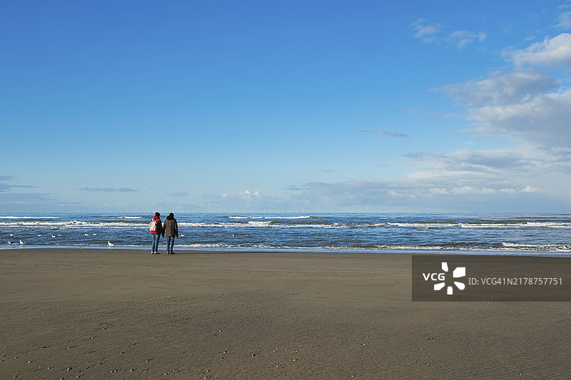 荷兰赞德沃特北海海滩上的一对情侣图片素材