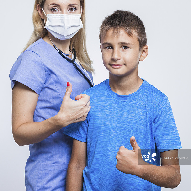 女牙医与竖起大拇指的男孩图片素材