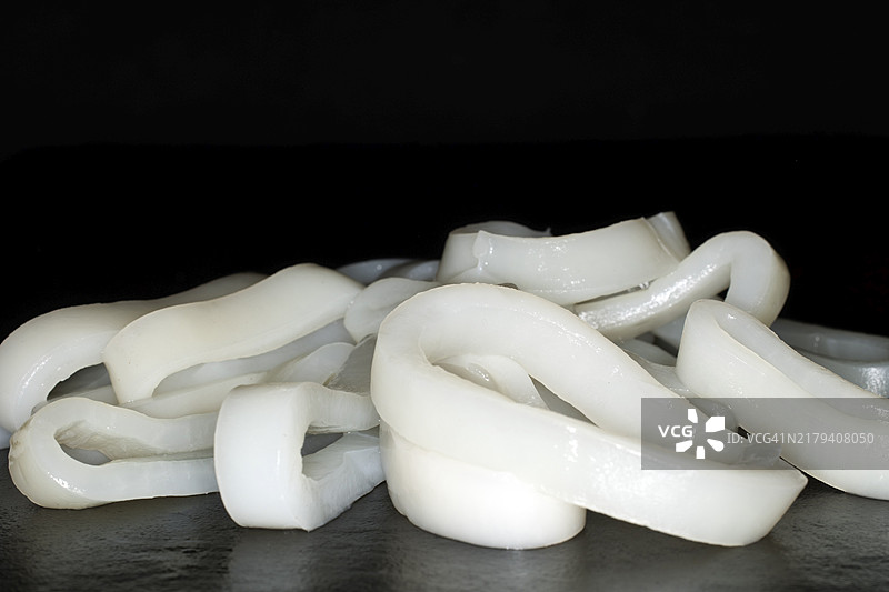 切开的鱿鱼圈，黑色背景图片素材