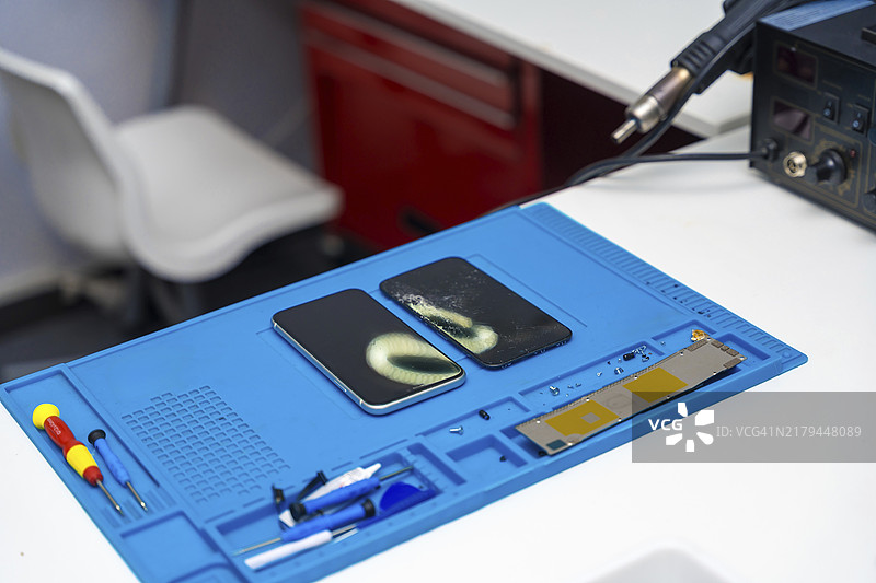 维修车间里打开的手机，俯视角度图片素材