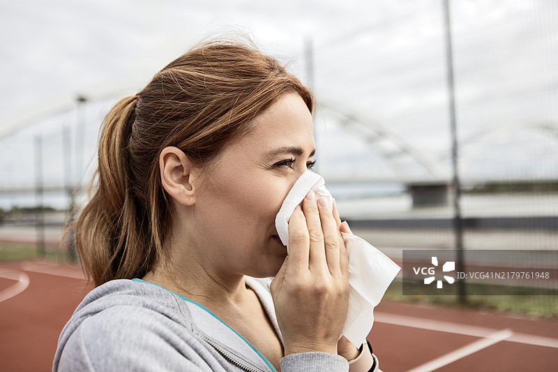 运动型女人锻炼时打喷嚏图片素材