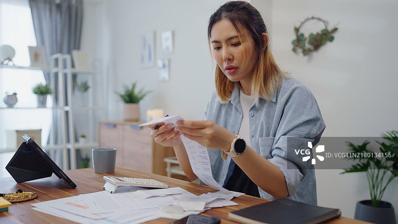 为财务问题苦恼的女人，计算账单支出图片素材