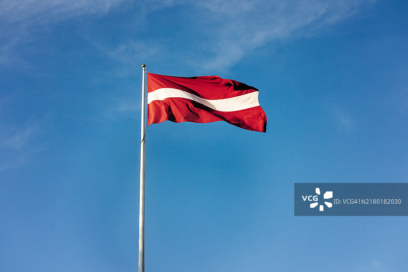 蓝天背景下的拉脱维亚国旗图片素材