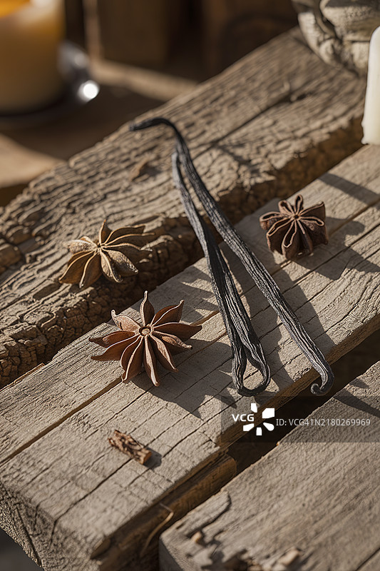 茴香种子、肉桂和香草放在磨损的木板上图片素材