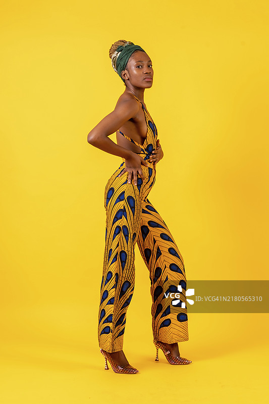 黄色背景中身着传统服饰的非洲年轻女子图片素材