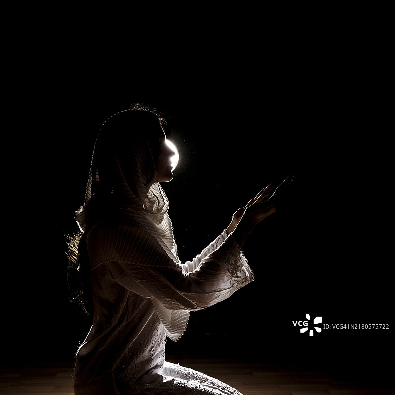 祈祷的穆斯林妇女轮廓剪影图片素材