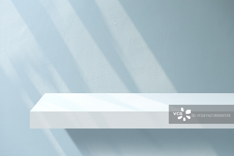 蓝色混凝土墙上的空混凝土架子图片素材