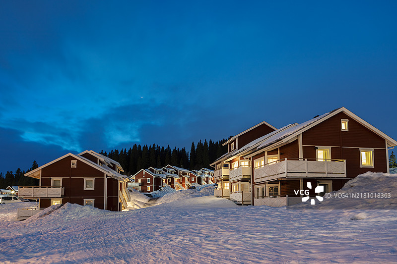 黄昏时分，阿尔卑斯冬季运动度假村中的小屋村庄。图片素材