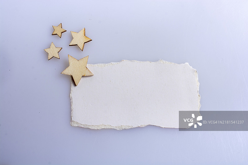 白色背景上撕裂的纸上的小木星图片素材
