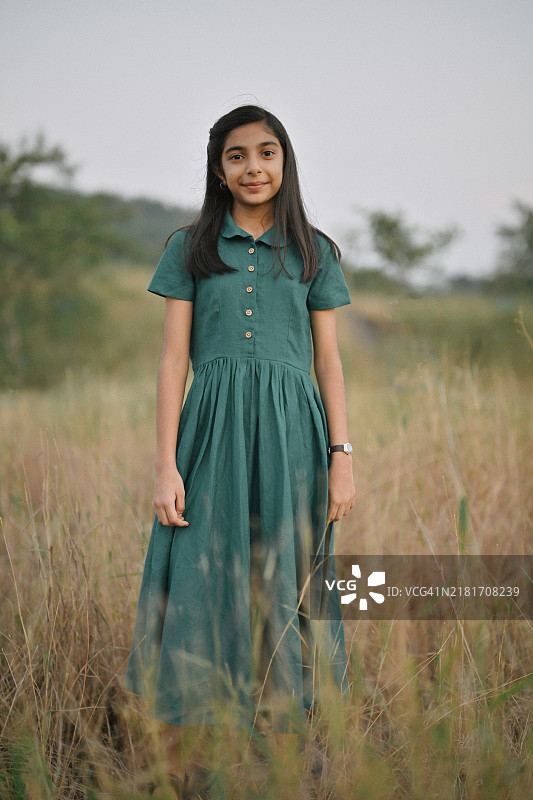 穿着经典绿色裙子的可爱小女孩肖像图片素材