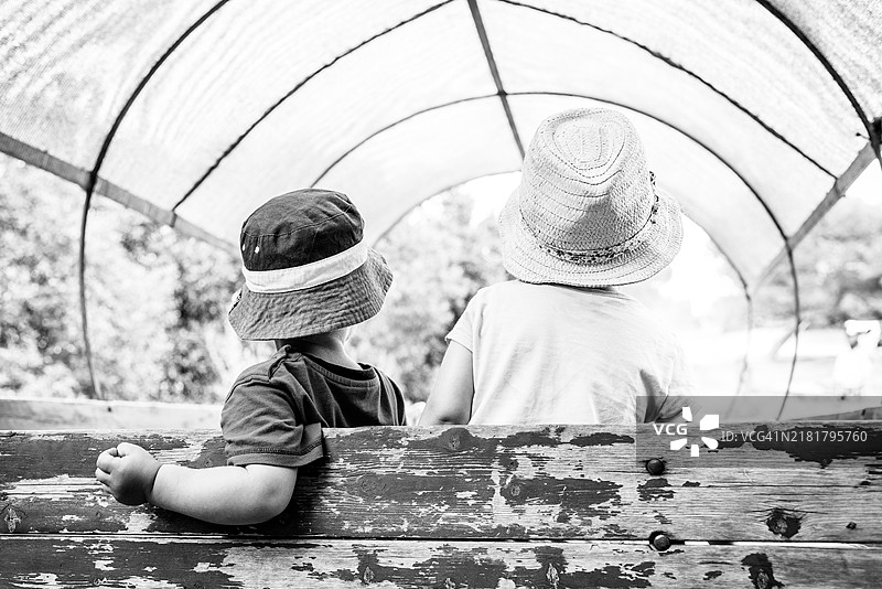 两个小孩坐在一辆旧马车里图片素材