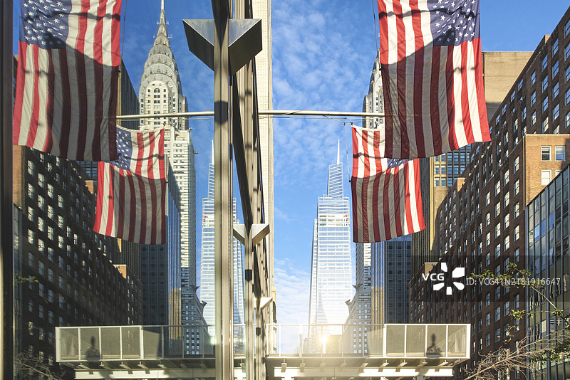 克莱斯勒大厦和美国国旗映照在建筑窗户上，纽约市，美国图片素材