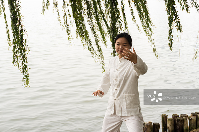 中国女性在早晨的公园里练习太极。图片素材