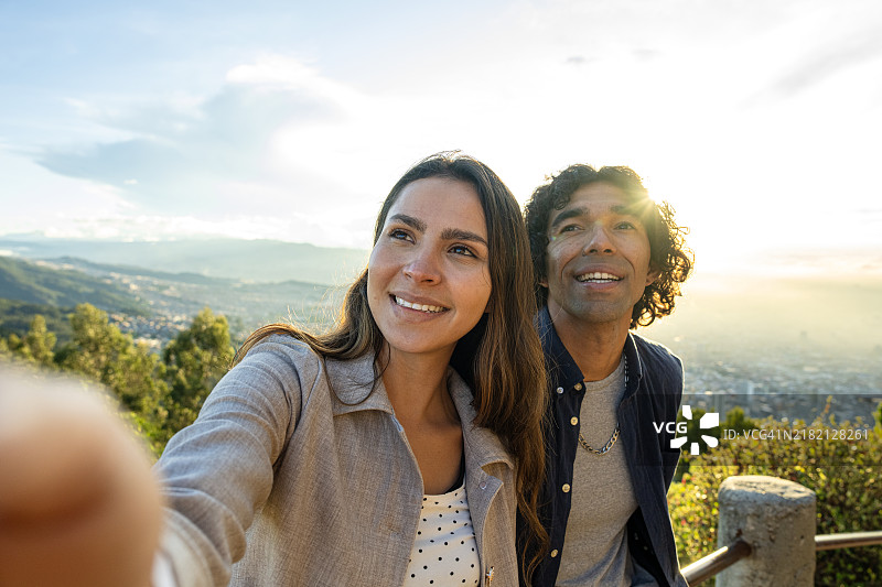 年轻的游客情侣在哥伦比亚波哥大蒙塞拉特山观光时自拍图片素材