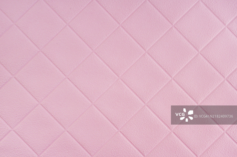 粉色纸张，带有菱形几何图案，作为背景的抽象纹理。图片素材