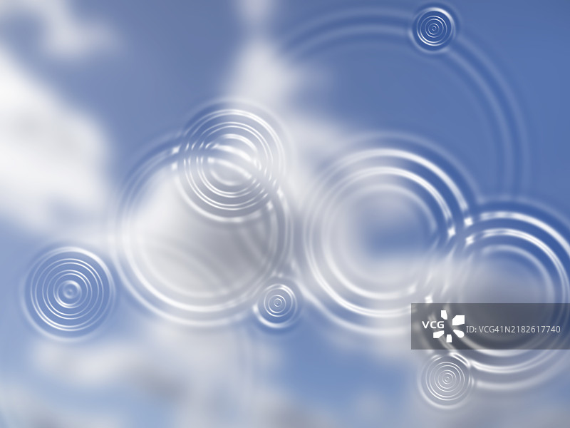 水面上倒映着蓝天和水滴形成的同心圆。图片素材
