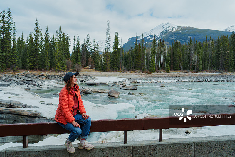 春季加拿大落基山脉的博河旁凝视的女性图片素材