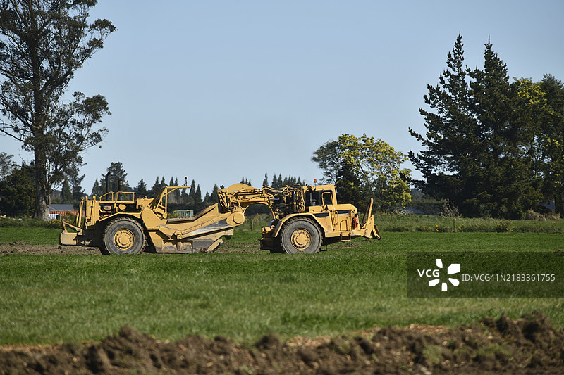 在新西兰坎特伯雷地区达菲尔德附近的一个物业上，一台大型挖掘机正在作业。图片素材