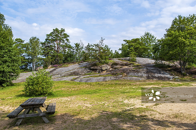 理想的休息场所和位于瑞典布莱金厄省霍尔姆斯约附近的斯托拉阿尔尤根湖岸边的岩石森林景观图片素材