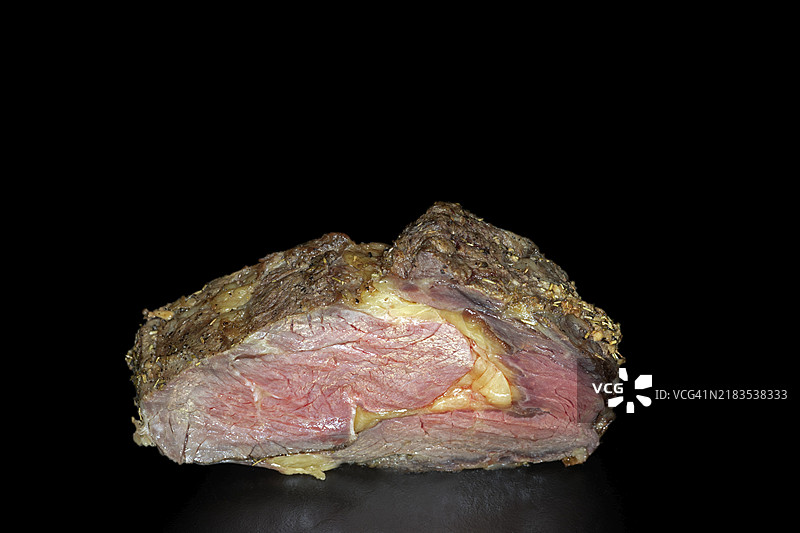 中等熟度的肋眼牛排，黑色背景的美食摄影图片素材