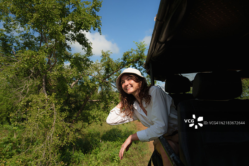 在斯里兰卡雅拉国家公园，一名女性从越野车中向外望去图片素材