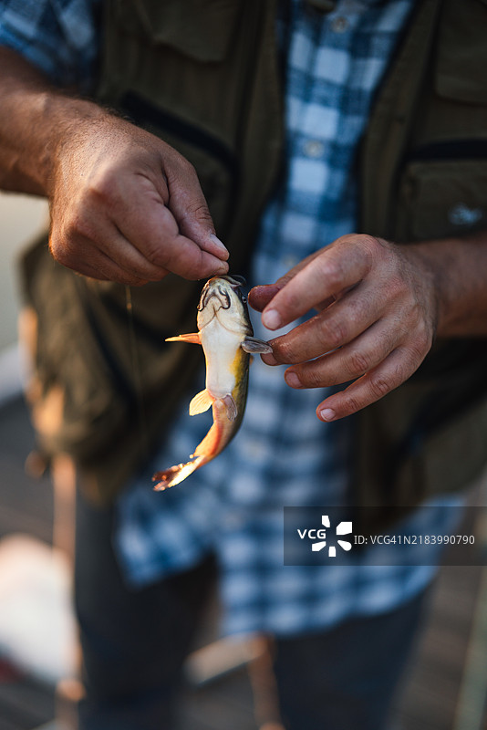 祖父与孙子们在湖边的钓鱼冒险图片素材