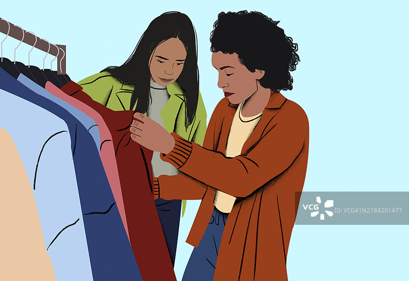 两个人在衣架上挑选衣服图片素材