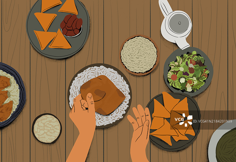 俯视餐桌，手在上菜，周围摆满了各种开胃菜和沙拉的盘子图片素材