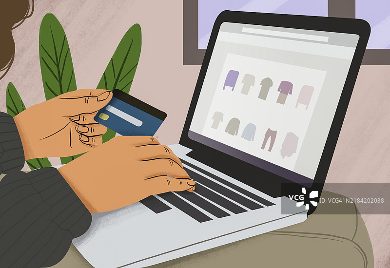 手握信用卡，正在笔记本电脑上输入，屏幕上显示在线购物界面图片素材