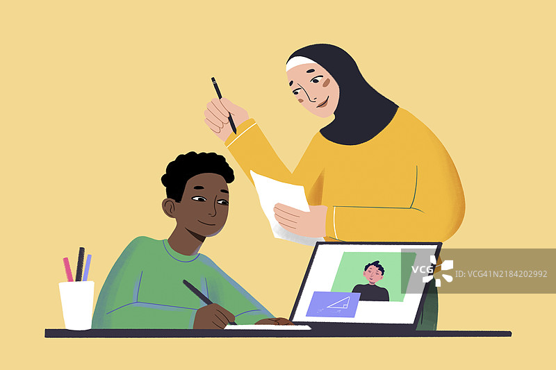 一位戴着头巾的老师在桌子旁帮助一位小学生画画，桌上有一台显示着另一个孩子照片的笔记本电脑。图片素材