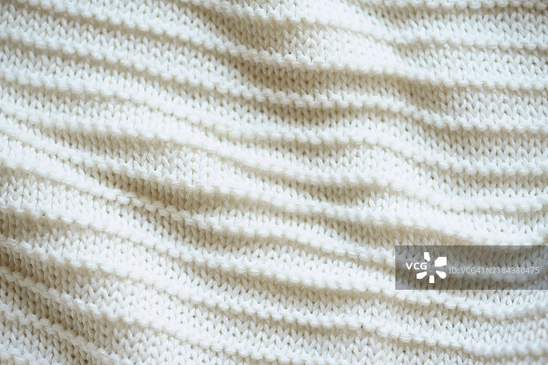 白色针织纹理背景特写。时尚色彩。图片素材