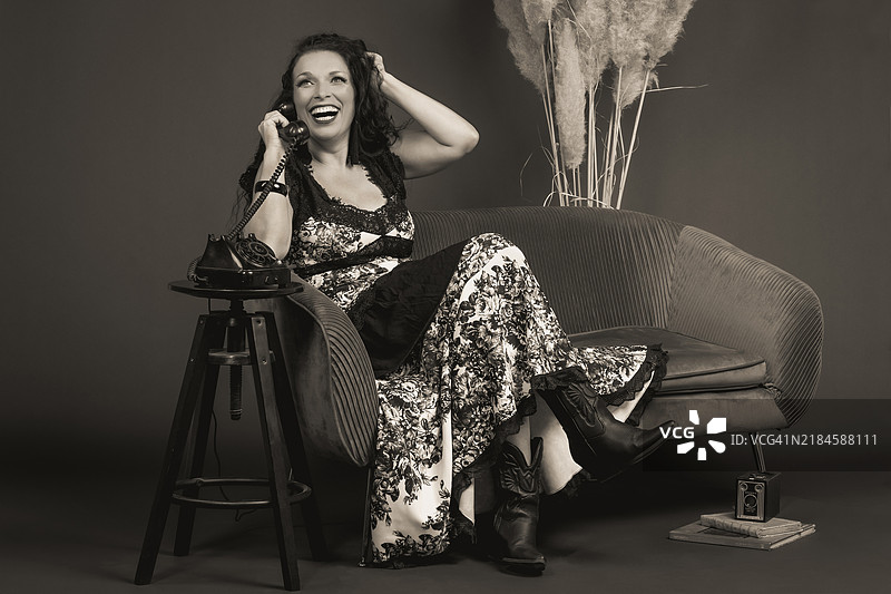 坐在复古椅子上的女性肖像，背景是墙壁图片素材