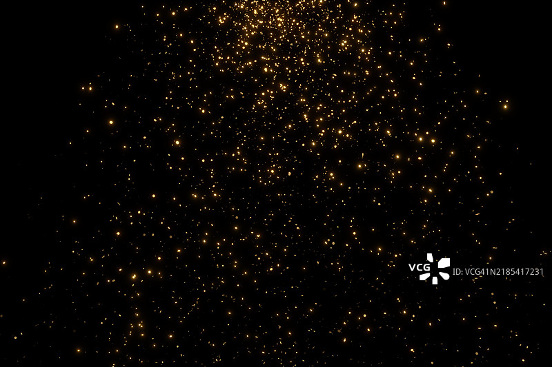 模糊的金色粒子在黑色背景上。节日背景。为您的设计提供节日多彩的背景。圣诞快乐，新年快乐。图片素材