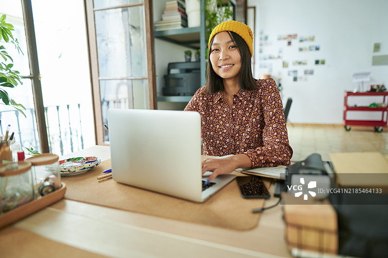 女性在办公室使用笔记本电脑图片素材