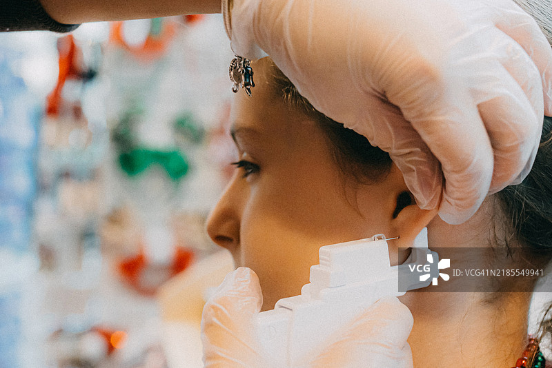 女孩在穿耳朵图片素材