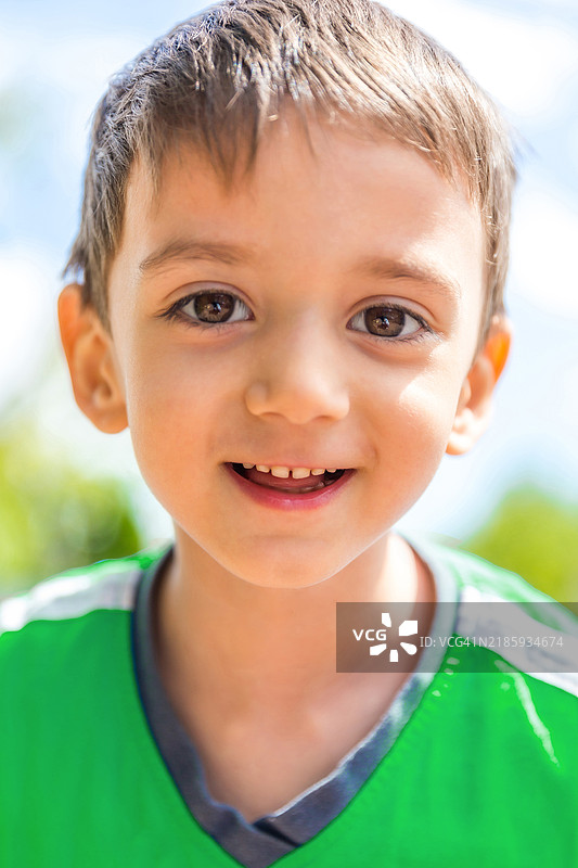 阳光下微笑男孩的特写镜头图片素材