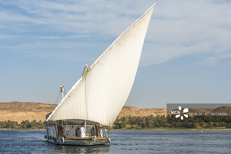 在埃及阿斯旺附近的尼罗河上航行的拉祖里舰队的乘客河船——达哈比亚帆船图片素材