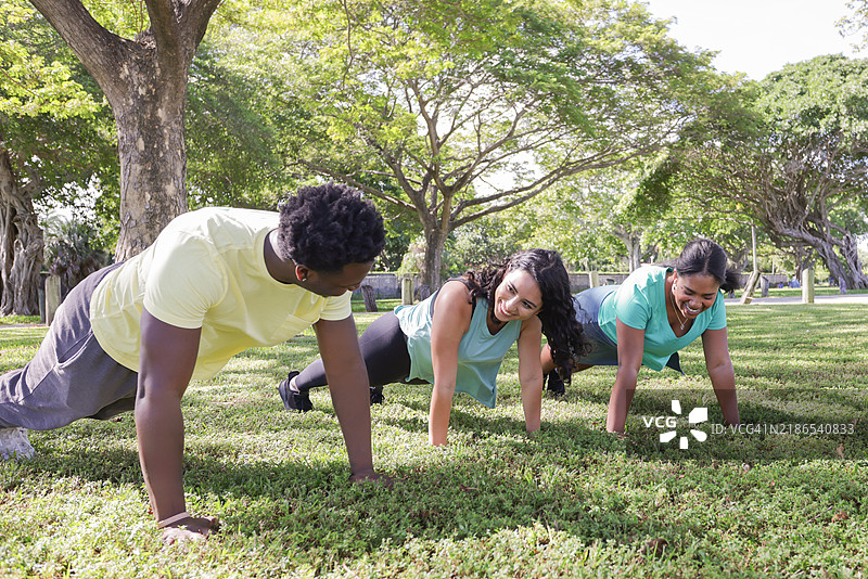 一群多种族的千禧一代朋友穿着运动服在公园一起锻炼。图片素材