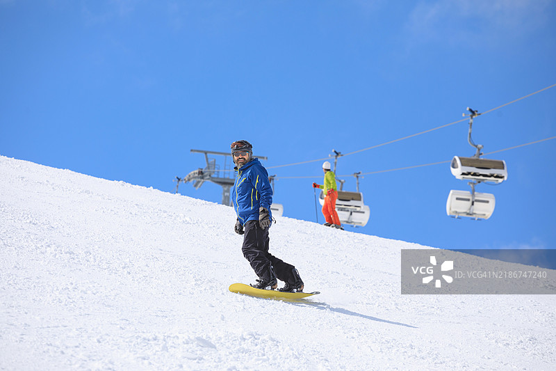 滑雪板运动员在山上的滑雪坡道上滑雪。意大利多洛米蒂超级滑雪区的塞拉隆达滑雪区。图片素材