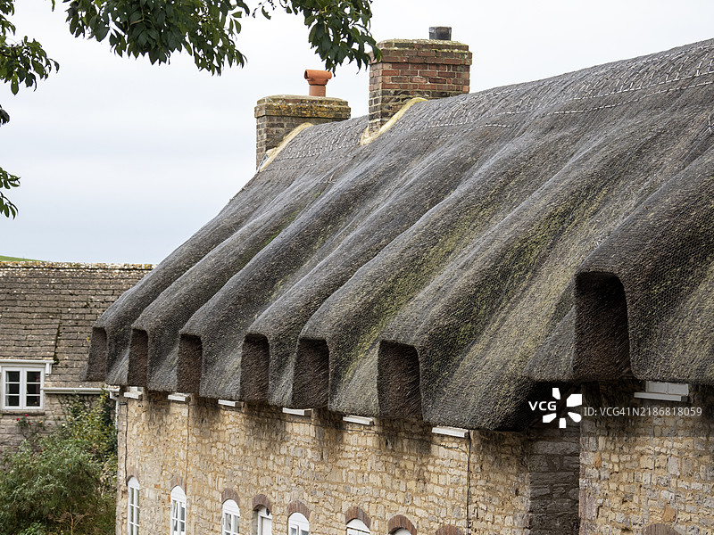 英国多塞特郡基默里奇的传统茅草屋。图片素材
