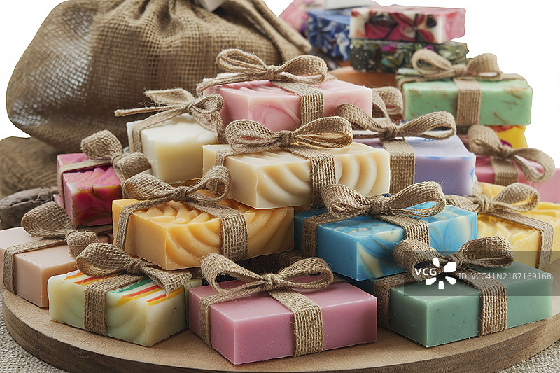 色彩缤纷的手工肥皂，配有麻布丝带，背景为白色图片素材