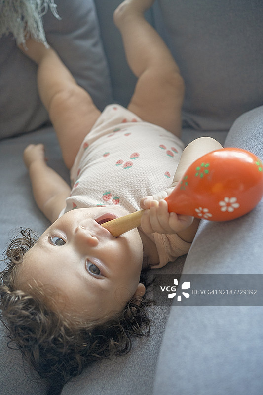 宝宝在沙发上玩马拉卡图片素材