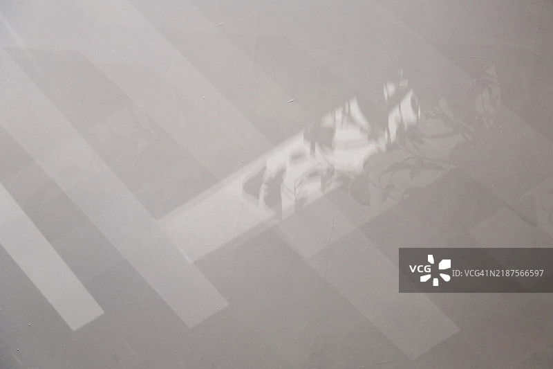 阳光照射下的混凝土墙背景中的光影图片素材